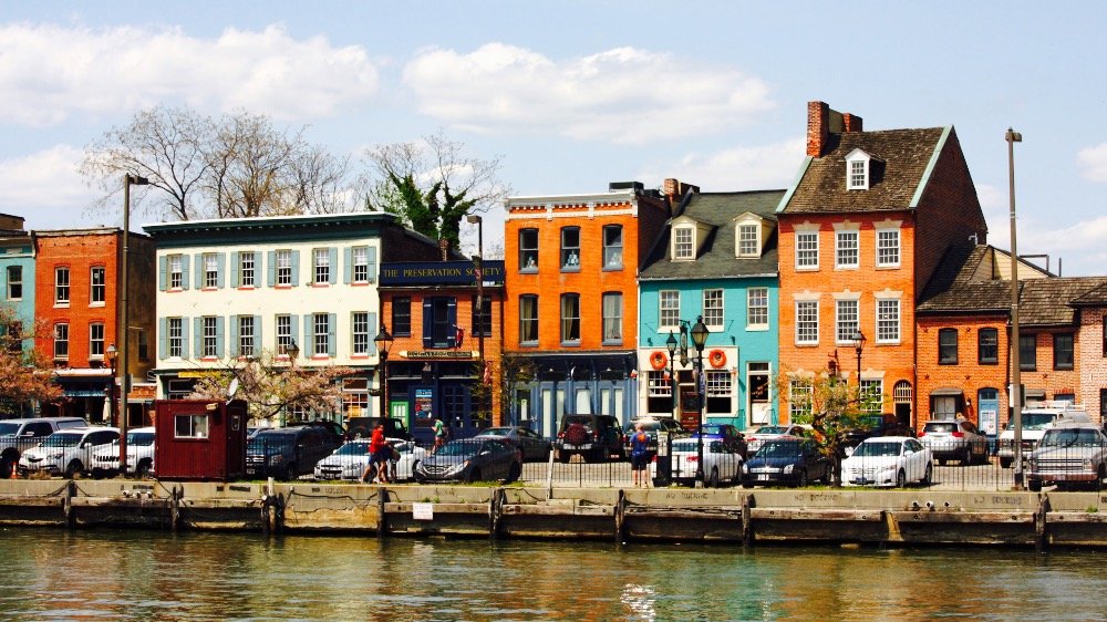 Colorful historic buildings line the waterfront in Fells Point, Baltimore.